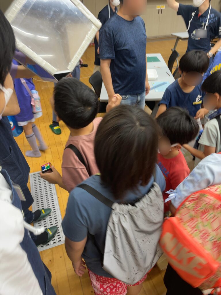 大きな「立体万華鏡」を覗く子どもたち