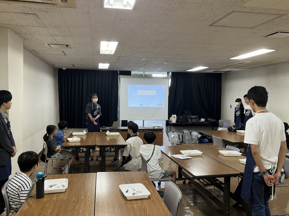 工作の説明を聞く子どもたち